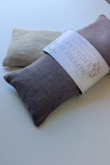 Lavender Linen Eye Pillow: Set of two rectangular linen pillows with organic flaxseed, one labeled as lavender.