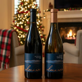 Two wine bottles from the brand 'alma rosa' on a white background