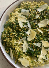 Risotto topped with greens, pine nuts, Parmesan, and a dollop of our small-batch Zucchini Pesto.