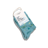 Preschool and youth Kids Socks that Protect Sea Turtles folded with a Conscious Step paper label