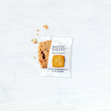 A Salted Caramel Single Shortbread Cookie, partially out of its package, with crumbs scattered nearby.
