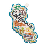 California Dog Toy: A cotton canvas embroidered with a bear, palm trees, Golden Gate Bridge, sun, and car.