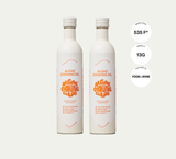 Two white Algae Cooking Oil bottles with benefits listed, side by side on a light background.