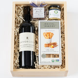 The A Night In Wine Gift Box features Rangeland Cabernet Sauvignon, Rustic Bakery organic sourdough flatbread, herb tapenade, and chocolate almond toffee—all beautifully presented in a wooden keepsake box.