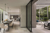 Modern open dining area featured in "At Home in the Wine Country: Architecture & Design in CA" Shows a long dark brown dining table, modern lighting and a granite fireplace