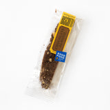 A California Biscotti - Single from Bread & Table, featuring visible roasted almonds and a “Good Food Awards” label, rests on a white background.