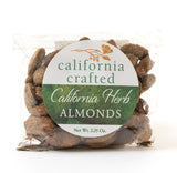 A clear plastic bag of California Herb Almonds - 2.5 oz, labeled with a round white and green sticker, offers delicious vegan snacks with savory flavor—ideal for herb almond fans.