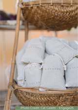 Wicker basket filled with lavender bags labeled 'Lavande' on a blurred background