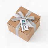 A brown gift box made from recycled paper sits on a white background, accented with a silver ribbon and bow, and featuring a Custom Logo Gift Tag.