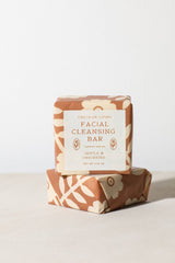 Two floral-wrapped soap bars are stacked on a light surface. The top bar's label reads Gentle Facial Cleansing Bar by Circular Living—an ultra-moisturizing, shea butter-enriched facial soap.