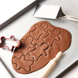 gingerbread ornament cookies in progress with the Gingerbread Ornament DIY Craft Kit’s all-natural salt dough mix and tools.