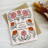 Grandma Mother's Day Greeting Card with pink and orange flowers on beige envelope, shown beside dried flowers.