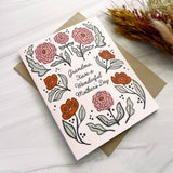 The Grandma Mother's Day Greeting Card features pink-orange flowers on a brown envelope, perfect for a botanical touch.