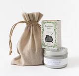 The Herbal Riviera Gift Set features a burlap drawstring pouch, Three Sisters Apothecary rosemary mint soap, and a Santa Barbara Company lavender candle tin, all artfully arranged on a white background.