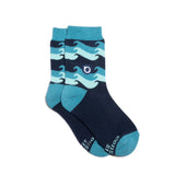 Kids Socks that Protect Oceans: Organic navy and teal socks with a wave pattern and single eye embroidery, finished with teal toes, heels, and cuffs—ideal for kids who care about healthy oceans.