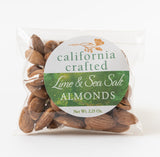 A clear plastic bag of Lime & Sea Salt California Almonds (2.5 oz) with a green and white label. The almonds are visible through the packaging.