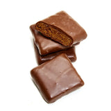 Three Milk Chocolate Caramelized Graham Crackers are stacked, with the top one broken in half to show the brown, crunchy interior. The background is plain white.