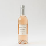 A clear glass bottle of Santa Barbara Rosé Gift Box wine with a silver screw cap, filled with pale pink rosé, displayed against a plain white background. The label showcases simple, elegant text.