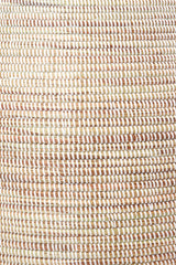 Close-up of the Senegalese Tall White Bongo Hamper Basket, featuring spiral bands in light brown, beige, and white.