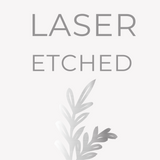 Gray text reading "Setup Fee: Laser Etching" is displayed above a subtle, silver-gray, laser-etched leaf design on a light background.