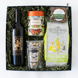 Gift box with Petite Sirah wine, snacks, and a puzzle on a white background
