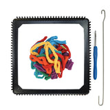 Black metal PRO potholder loom holding a pile of multicolor cotton loops, with a weaving hook and bind-off hook