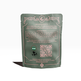 A green pouch shows Chocolate Covered Dates | Pistachio Butter, ingredients, nutrition facts, QR code, and certifications.