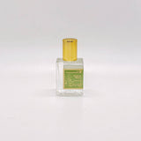 A small square bottle of Sunday Olive Perfume Oil with a yellow cap and green label, on a plain white background.
