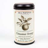 A tin of Cinnamon Orange Spiced Black Tea with biodegradable teabags and an illustrated orange branch on the label.