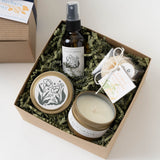 California Spa Gift Box with candle, spray, soap & matches on shredded paper, viewed from above.