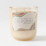 California Dreamin Candle - 9 oz: Beige soy wax, glass jar, wavy pastel label, sustainable and eco-friendly.