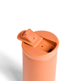 Ceramic Coated Travel Mug in Terracotta with flip-top lid, viewed from above on a white background.