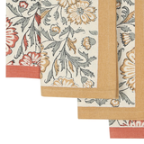 Bloom Sienna Napkins: three stacked kora cotton napkins, hand block printed with floral patterns in red, yellow, and green.