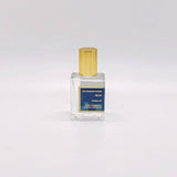 Blue Perfume Oil—glass roll-on with gold cap and blue label—is displayed on a white background.