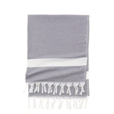 Custom Logo Band beach & bath towel with white stripes and tassels, neatly folded on a white background.