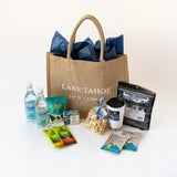 Example of a curated Lake Tahoe Welcome Bag with water, snacks, jerky, soap and more.