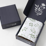 Open Mistletoe Holiday Gift Box with floral wrap beside a Santa Barbara Company box—ideal for festive cookies.
