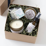 Santa Barbara Spa Gift Box with candle, soap, spray bottle, and cream jar on shredded paper filler.