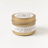 Santa Barbara Travel Candle, 3oz soy, gold tin with white lid—compact and floral-scented, ideal for travel.