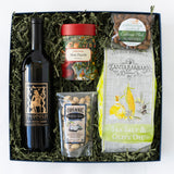 Gift box with wine, snacks, and a puzzle on a white background