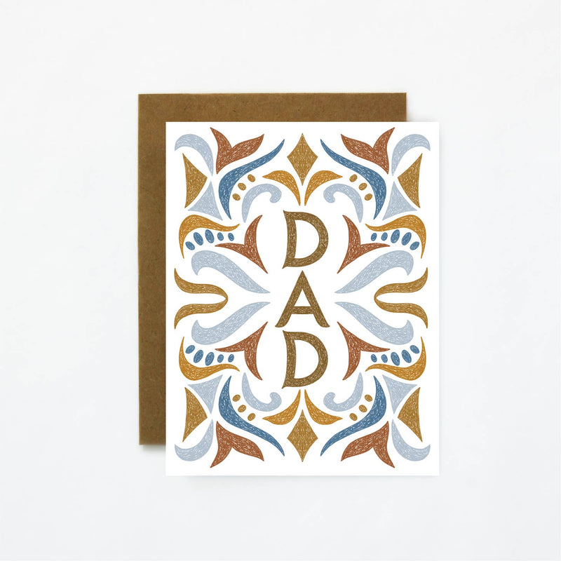 A card featuring the word dad surrounded by a festive pattern in light blue, brown and dark blue.