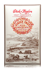 The Ginger Snap Milk Chocolate bar by Dick Taylor features red and gold decorative text on its packaging, with cows grazing by a coastal landscape—an ideal treat for ginger snap cookie chocolate fans.