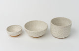 A Handmade Klapp Ceramic Planter from Atlas Klapp Ceramics in Santa Barbara sits on a white background, featuring an off-white glaze with brown speckles and a simple design.