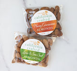 Two clear bags of California Crafted roasted almonds are shown: one is Honey Cinnamon and the other is Lime & Sea Salt California Almonds - 2.5 oz. Both feature colorful labels in white, green, and orange tones.