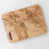 The Map of San Francisco Cutting Board features a detailed engraving of San Francisco, Oakland, and local landmarks—ideal as a unique Bay Area gift or as a stylish engraved prep board for your kitchen.