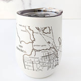 The Map of the San Francisco Bay Area Insulated Wine Tumbler is a white stainless steel tumbler with a clear lid, featuring a minimalist line map of iconic SF neighborhoods—Golden Gate, Marina, Mission, and Haight—perfect as a Bay Area gift.