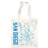 The San Diego Map Tote features a blue illustrated map of the city, highlighting neighborhoods, landmarks, and the coastline. "SAN DIEGO" is printed vertically on the side—perfect as a unique tote or thoughtful gift.