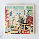 A vibrant illustration of San Francisco’s cable cars, bustling streets, skyscrapers, and the Bay Bridge graces these San Francisco Travel Poster Coasters—ideal for adding city charm to your home.