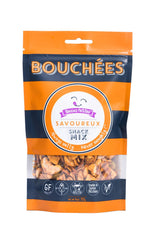 A resealable bag of Savoureux Snack Mix, with orange and navy stripes, product branding, gluten-free, dairy-free, keto, and home kitchen icons at the bottom. Snacks are visible through a clear window.