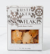 A box of Snowflake Vanilla Butter Cookies features silver snowflake designs and black text on white packaging with a window displaying the snowflake-shaped cookies inside. Net weight: 5 oz (142g)—a festive holiday favorite.